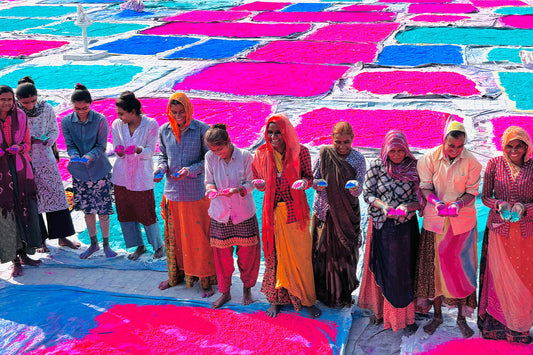 Women workers at an Indian gulal factory packaging colour powder